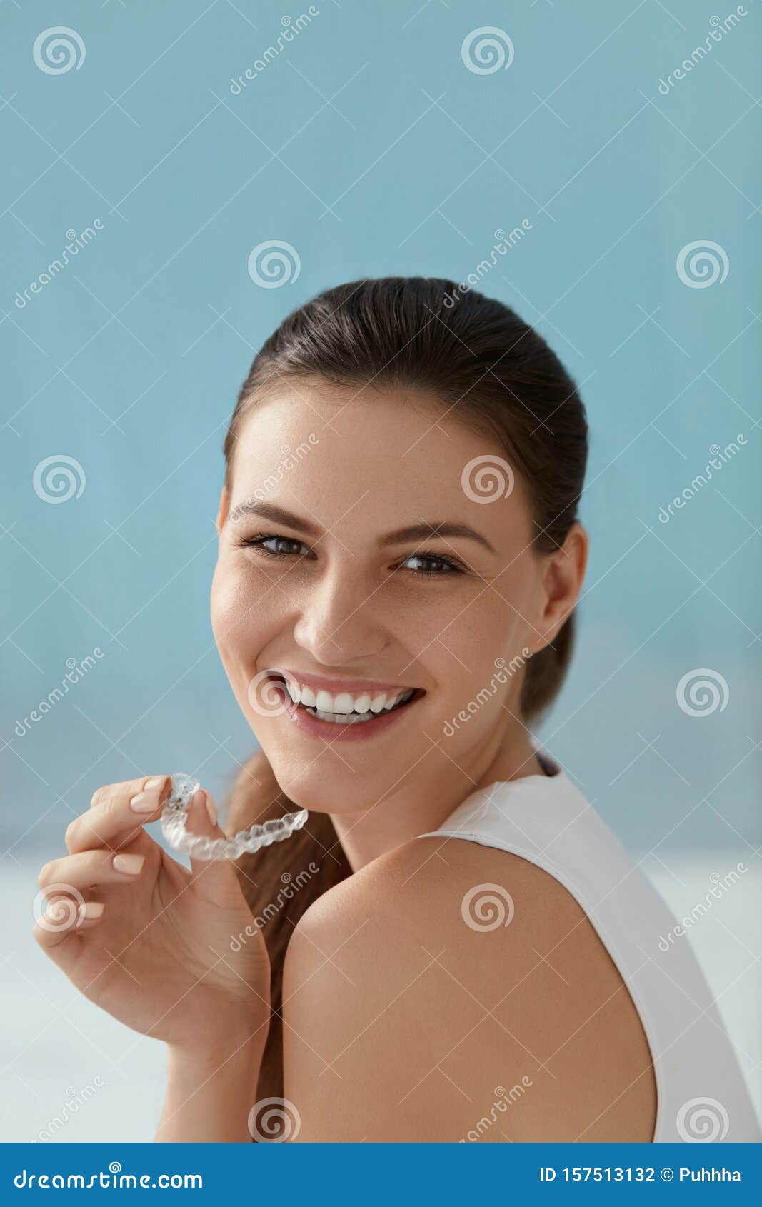 dental care. smiling woman with white smile using whitening tray