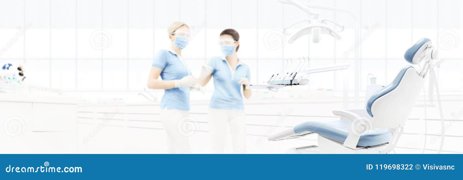 dental clinic interior with doctors, blurred background for copy