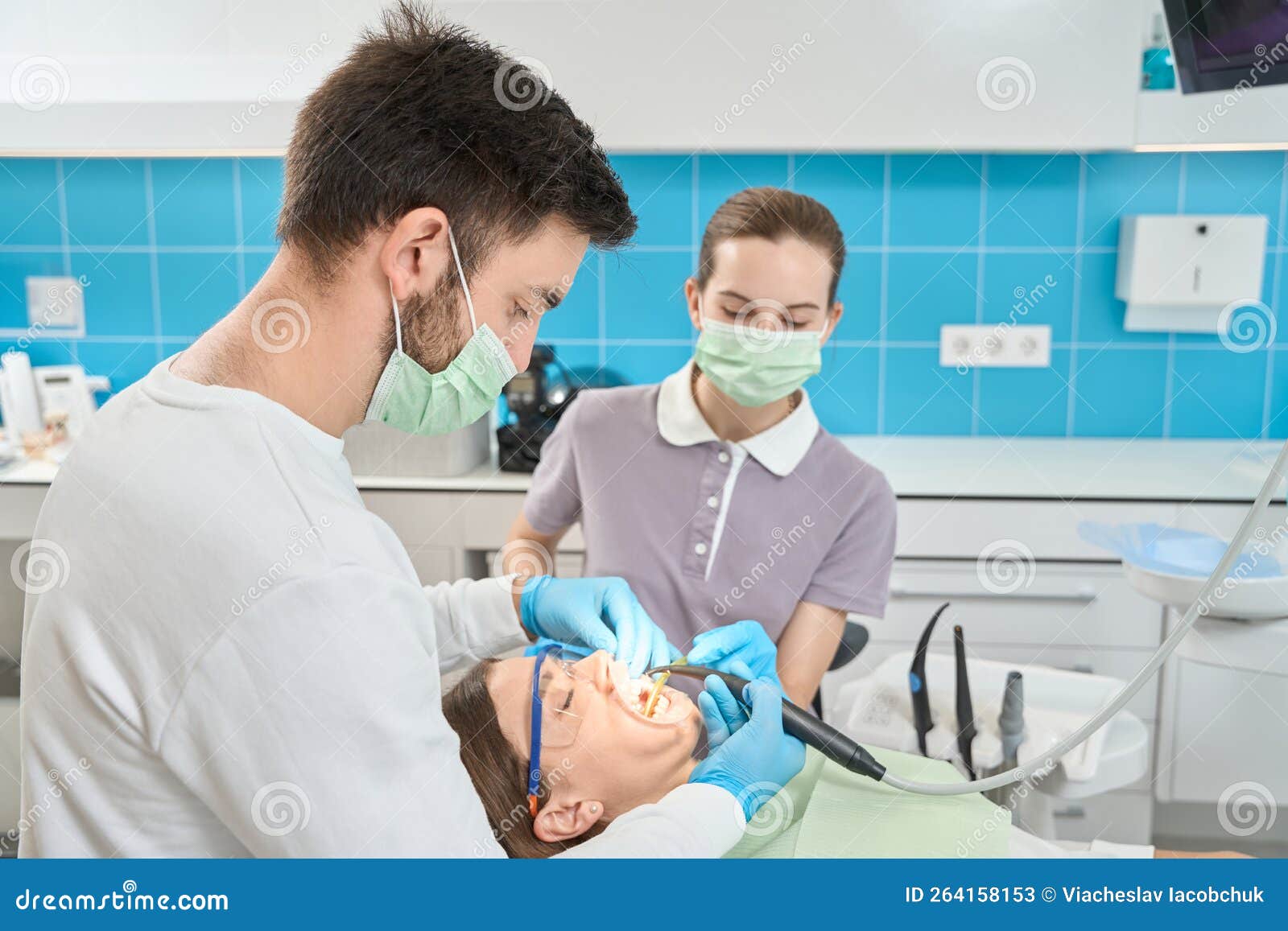 Dental Conducting Teethwhitening Procedure on Client Assisted by Nurse