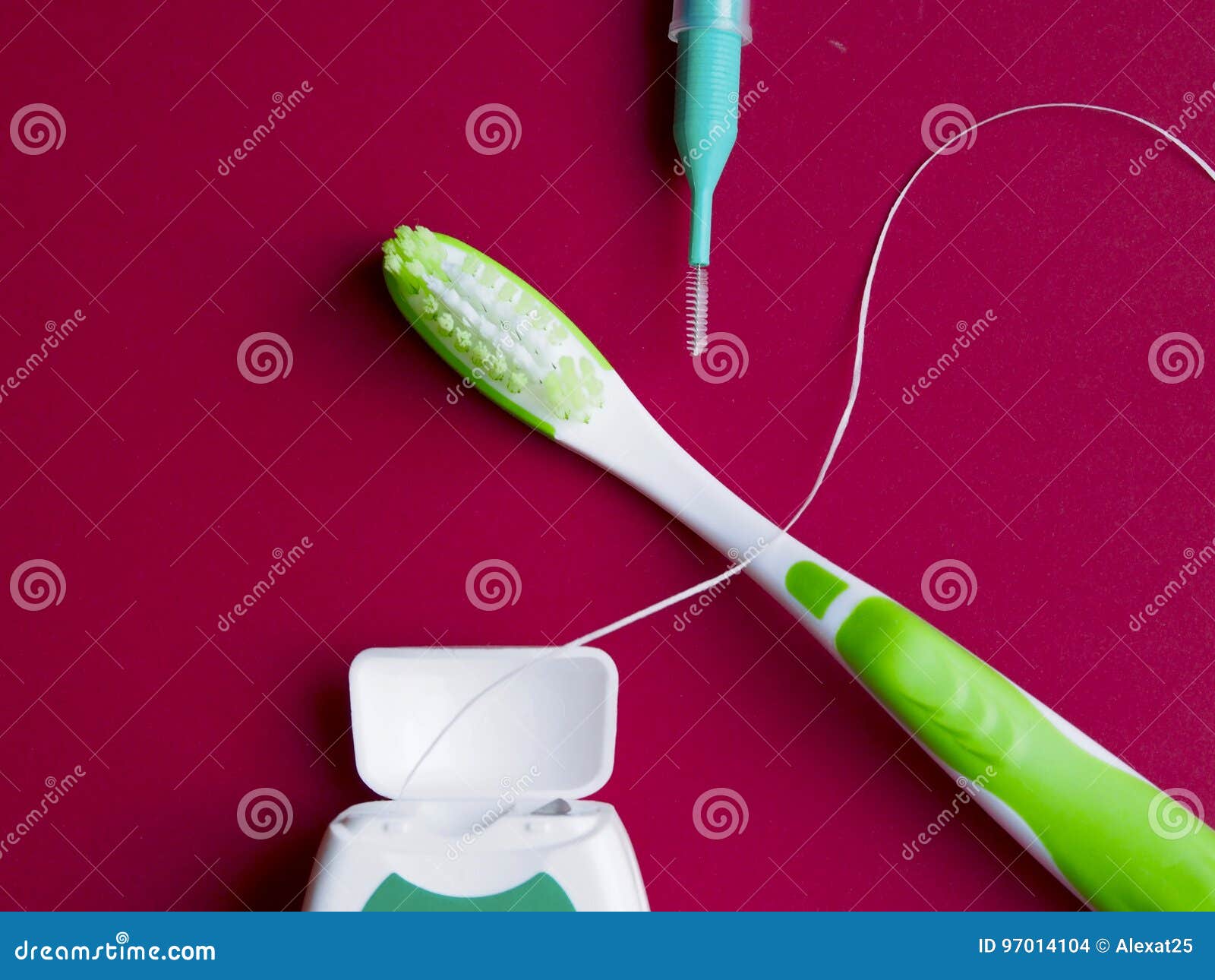 Dental Floss, Interdental Brush and Toothbrush on Red Background Stock