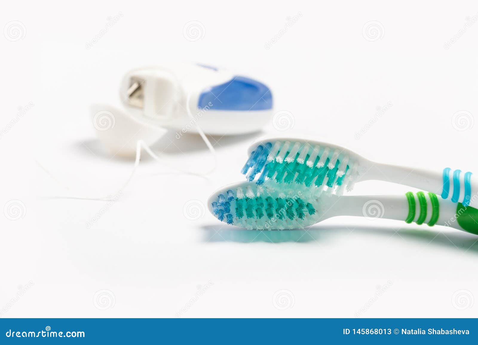 Dental Floss and Toothbrush Isolated on a White Background Stock Image