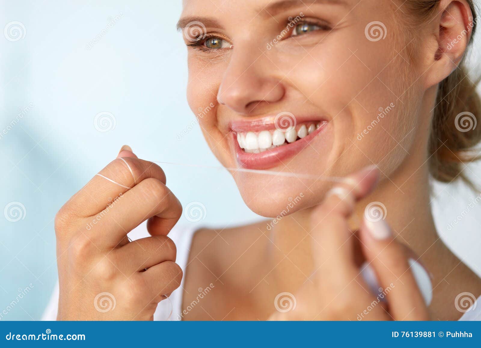 dental hygiene. beautiful woman flossing healthy white teeth
