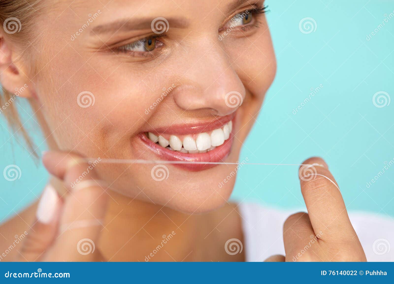 dental hygiene. beautiful woman flossing healthy white teeth