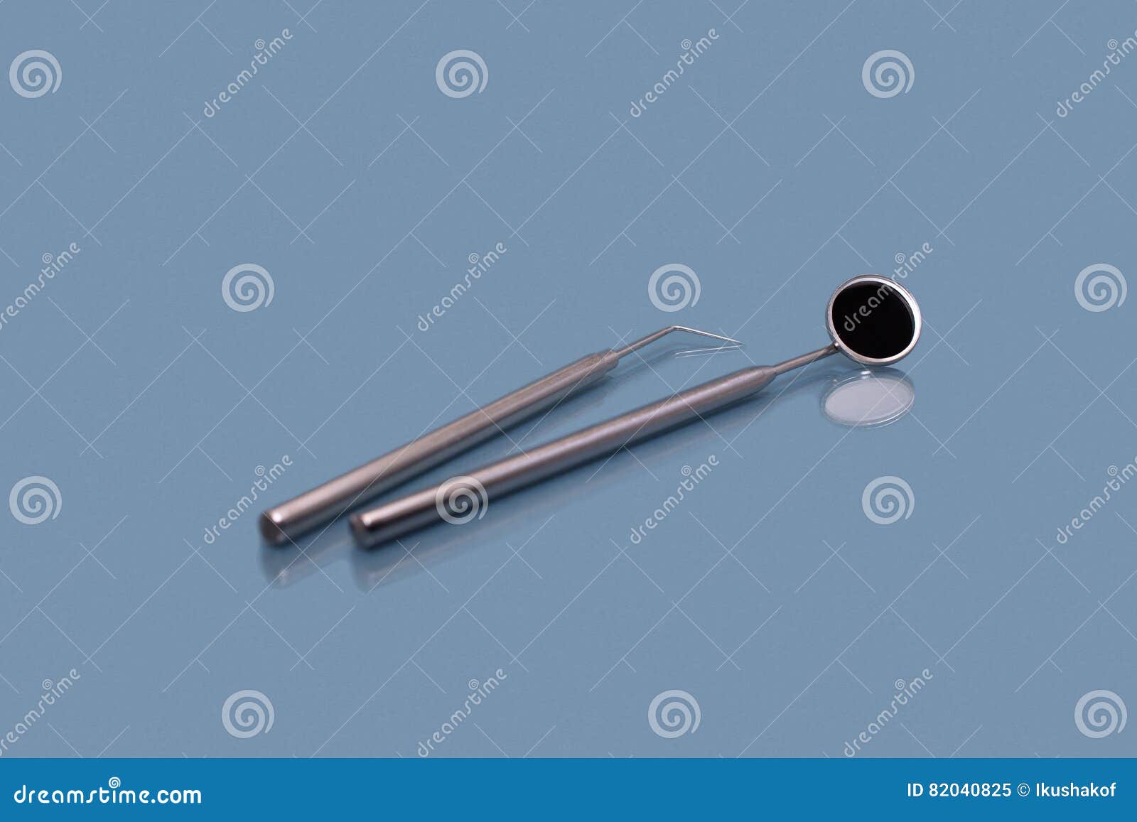 Dental Mirror and Dentist Probe. Image on Blue Background Stock Image