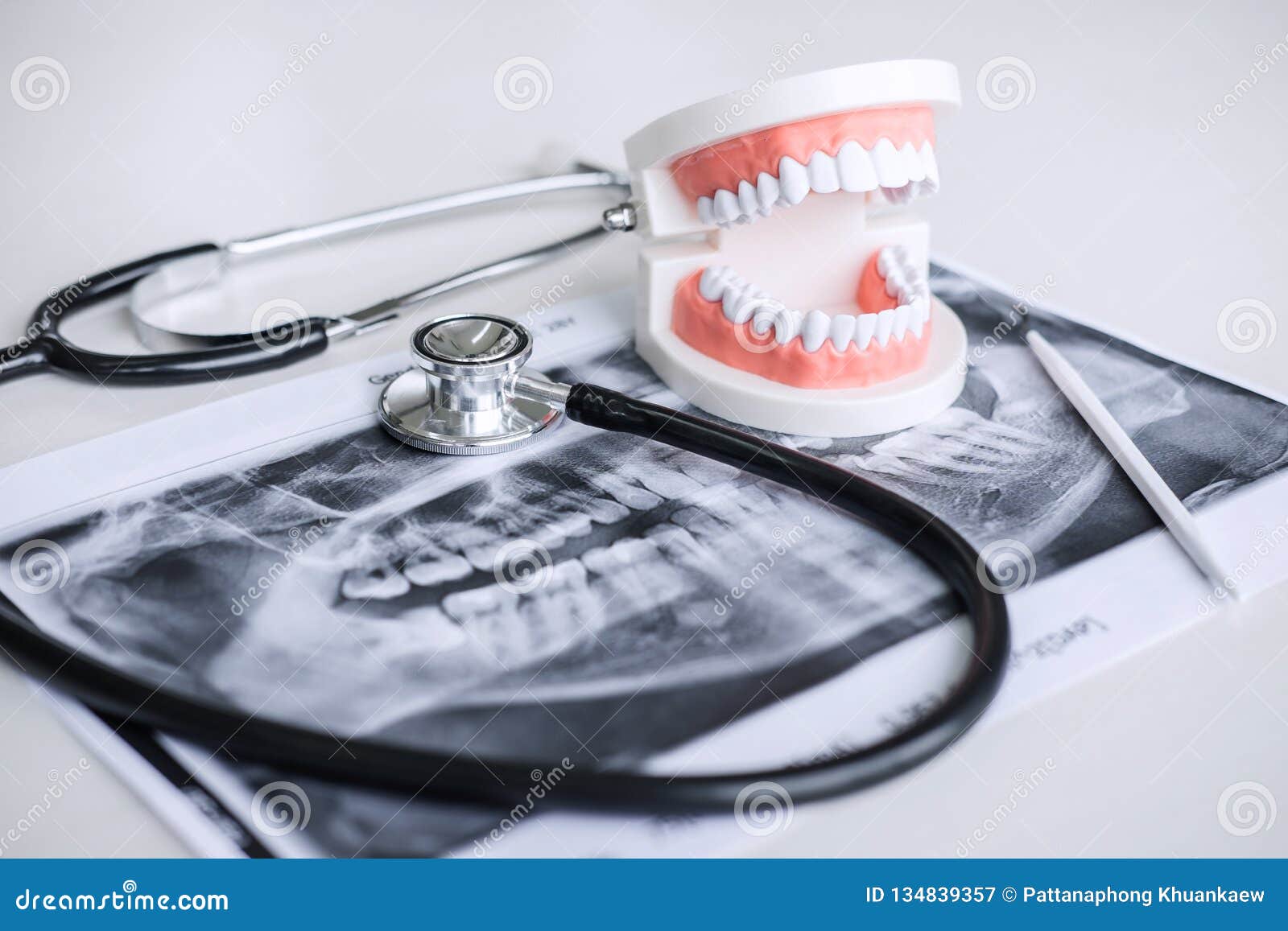 dental model and equipment on tooth x-ray film and stethoscope used in the treatment of dental and dentistry by dentist