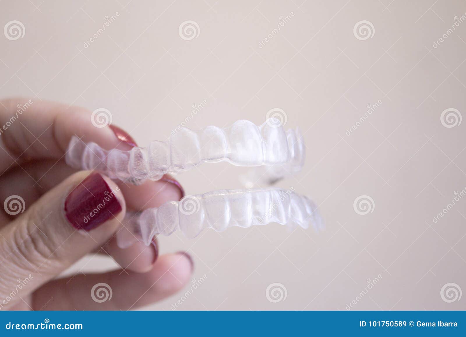 invisible dental orthodontics held by a woman