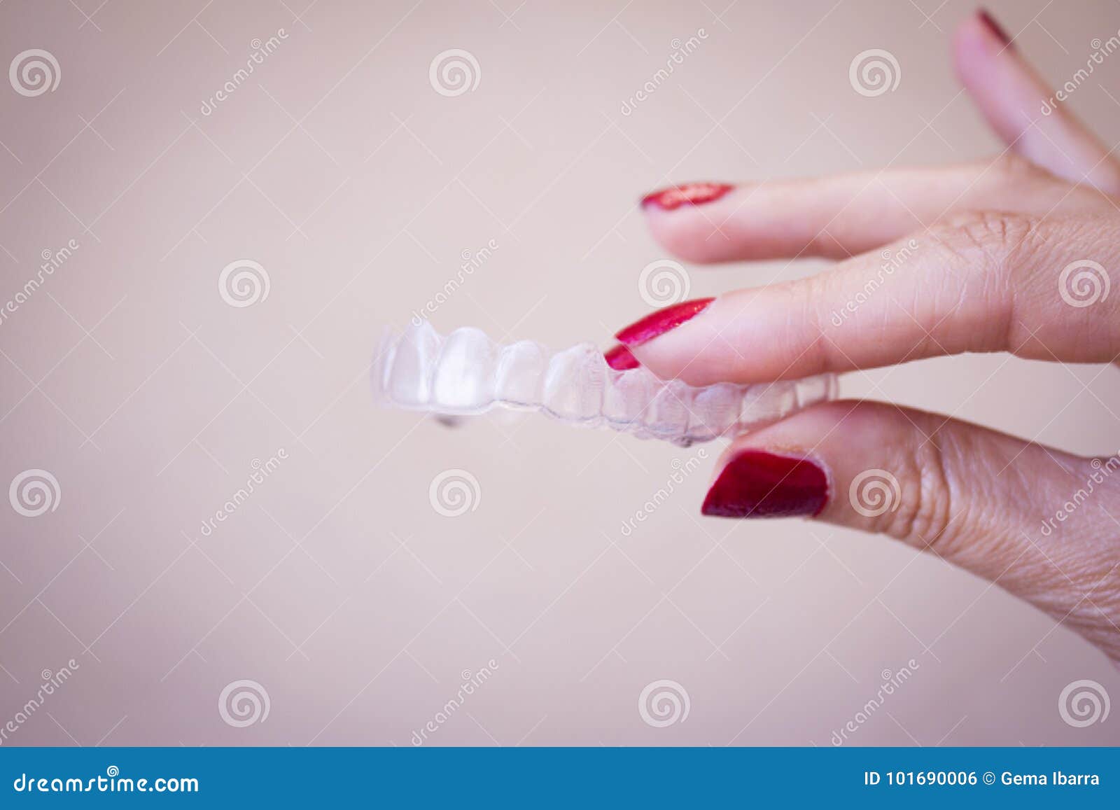 invisible dental orthodontics held by a woman