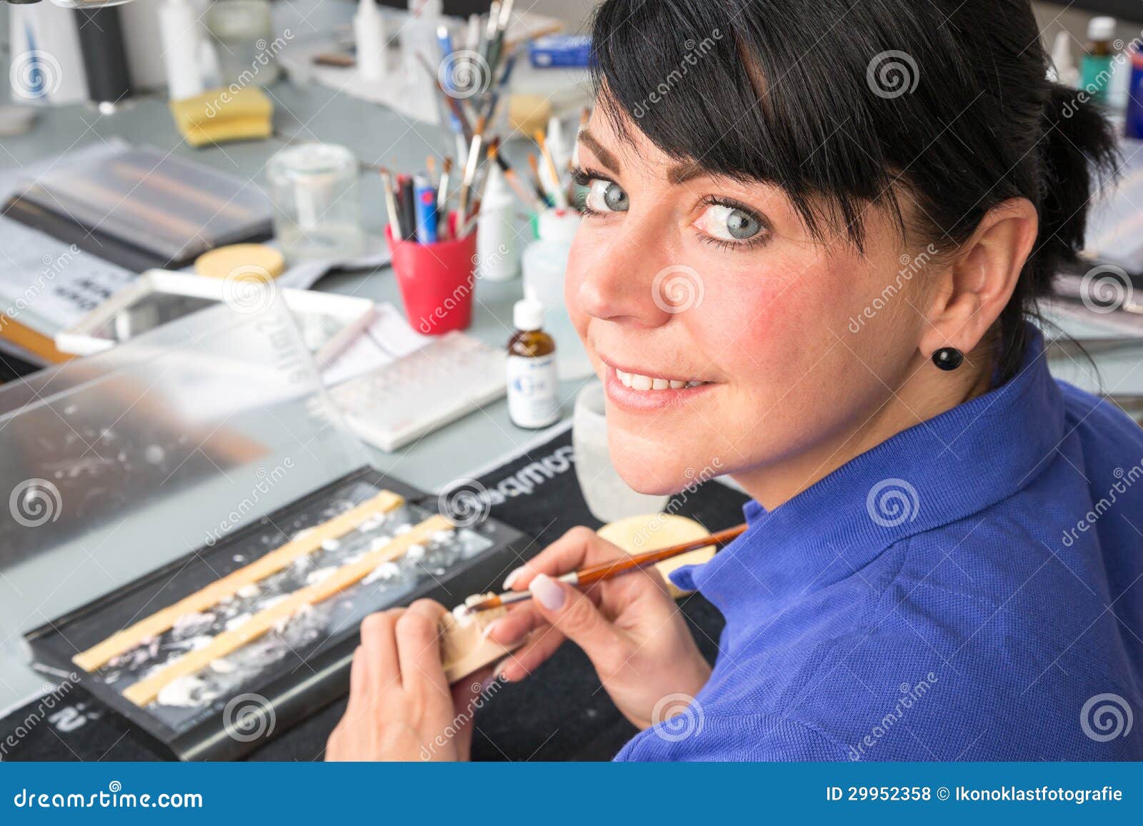 Technician in a Dental Laboratory Applying Ceramics To a Prosthesis