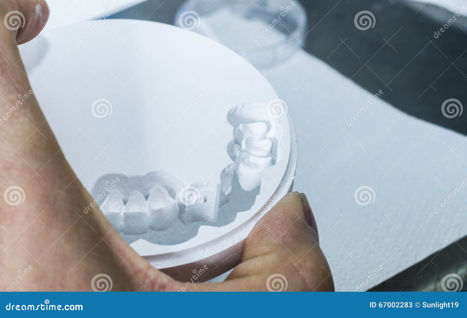 Dental Technician is Extracting Teeth in the Zirconia Disc. Stock Image