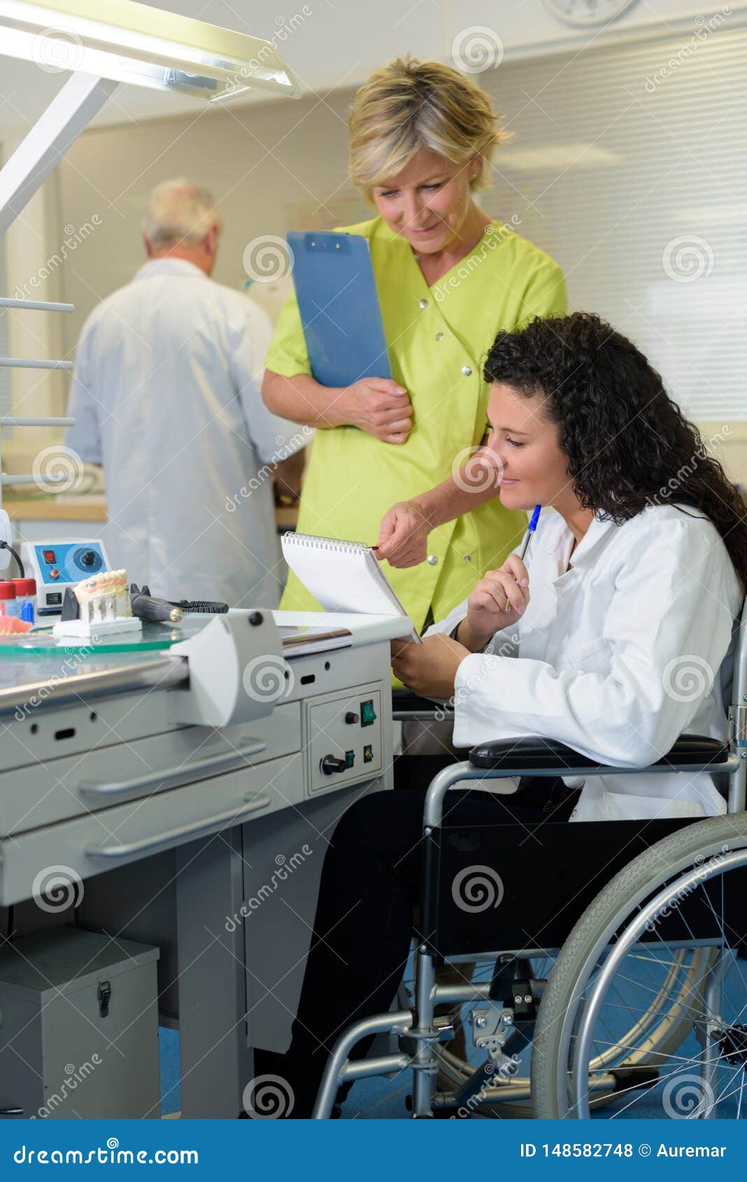 Dental Technician Supervisor Showing Note To Handicapped Intern Stock