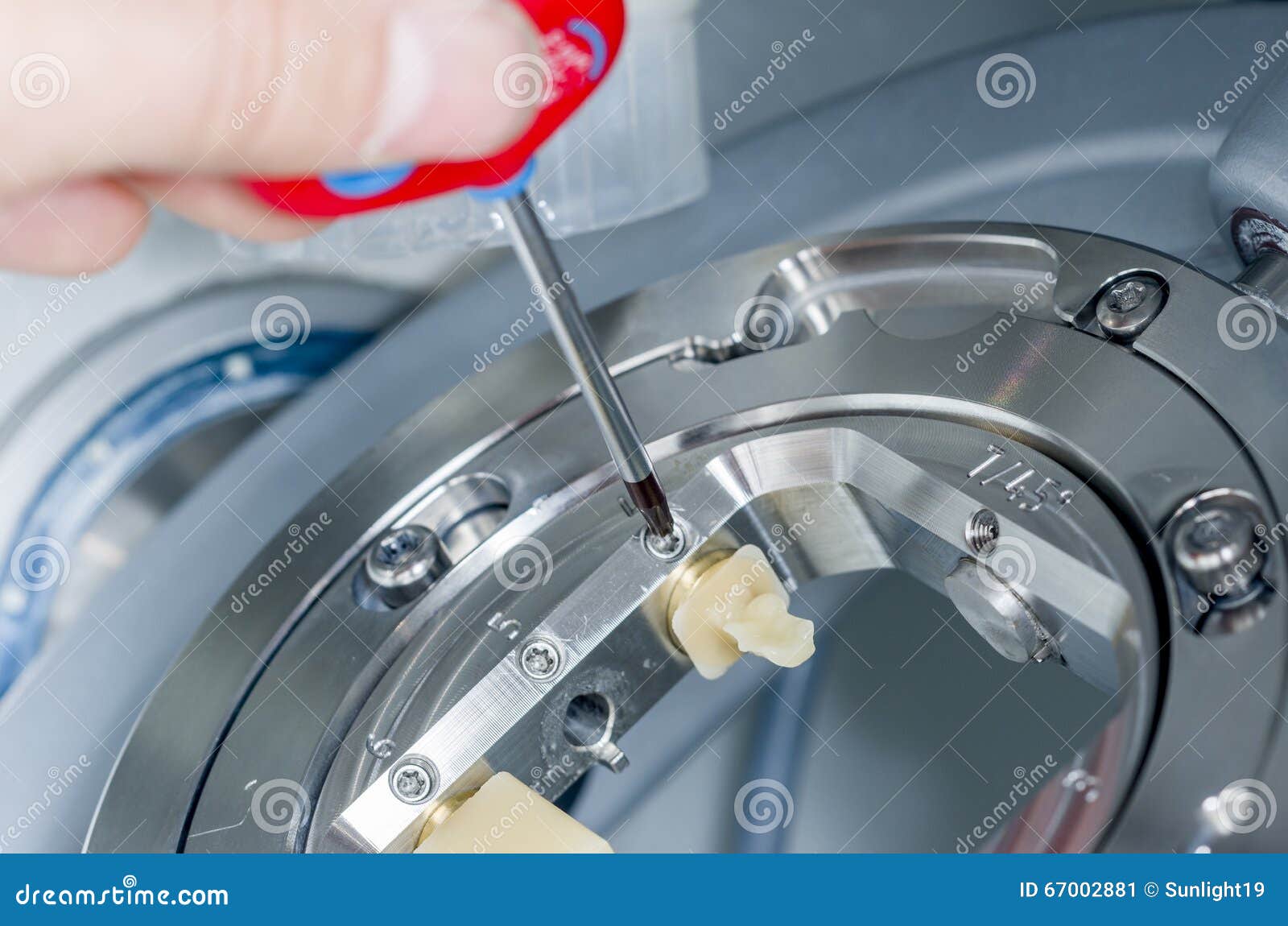 dental technician unscrew the hybrid ceramics the milling machine.