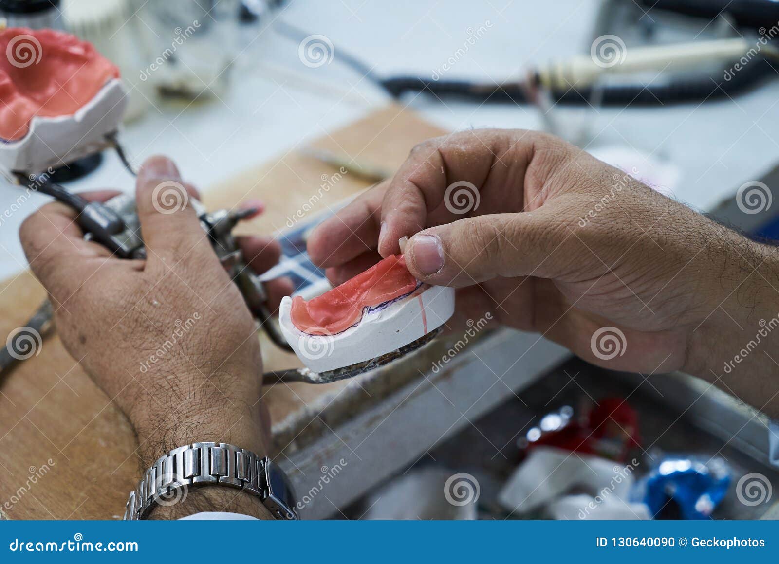 Dental Technician Using a Knife with Ceramic Dental Implants Stock