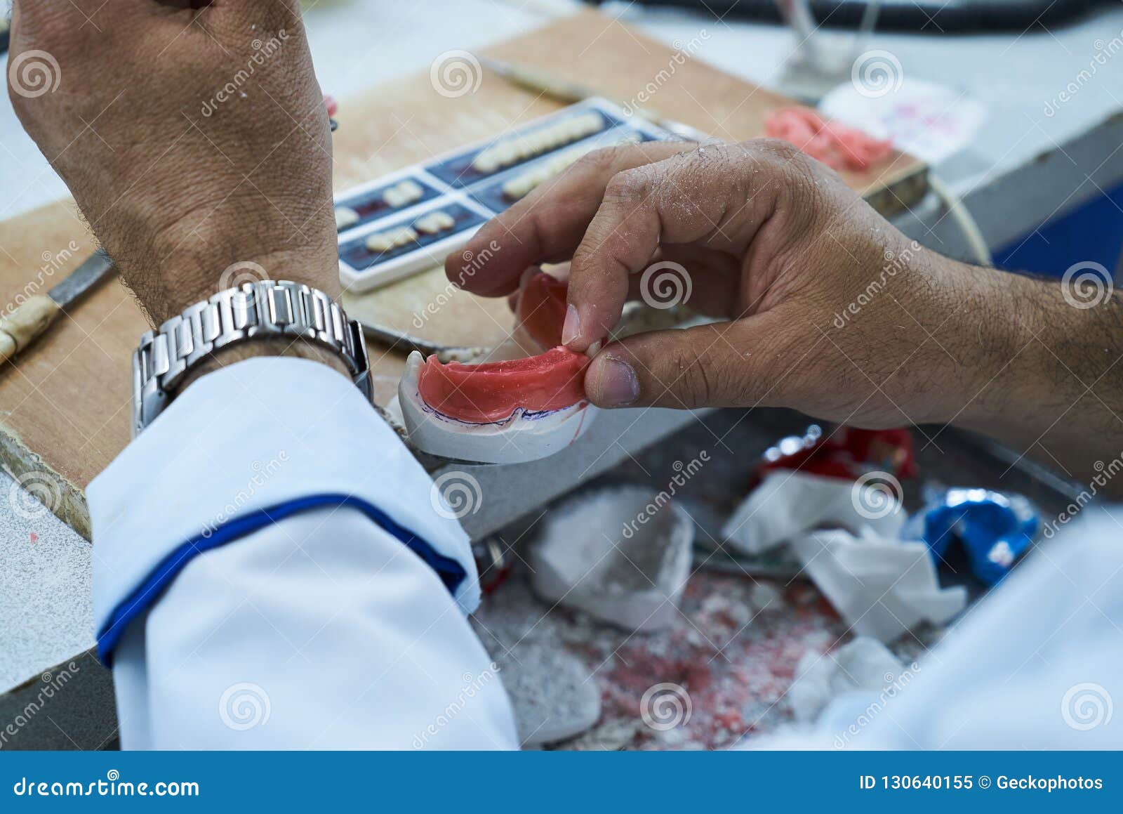 Dental Technician Using a Knife with Ceramic Dental Implants Stock