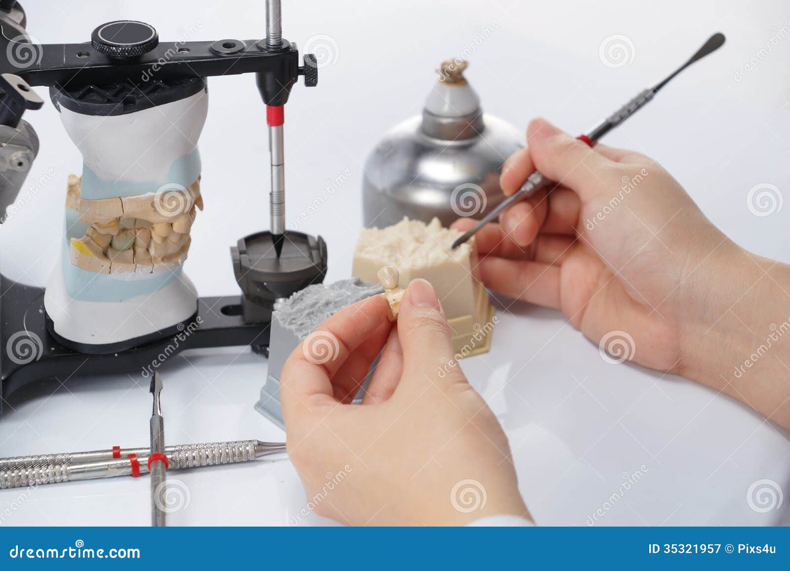 Dental Technician Working with Articulator in Dental Laboratory Stock