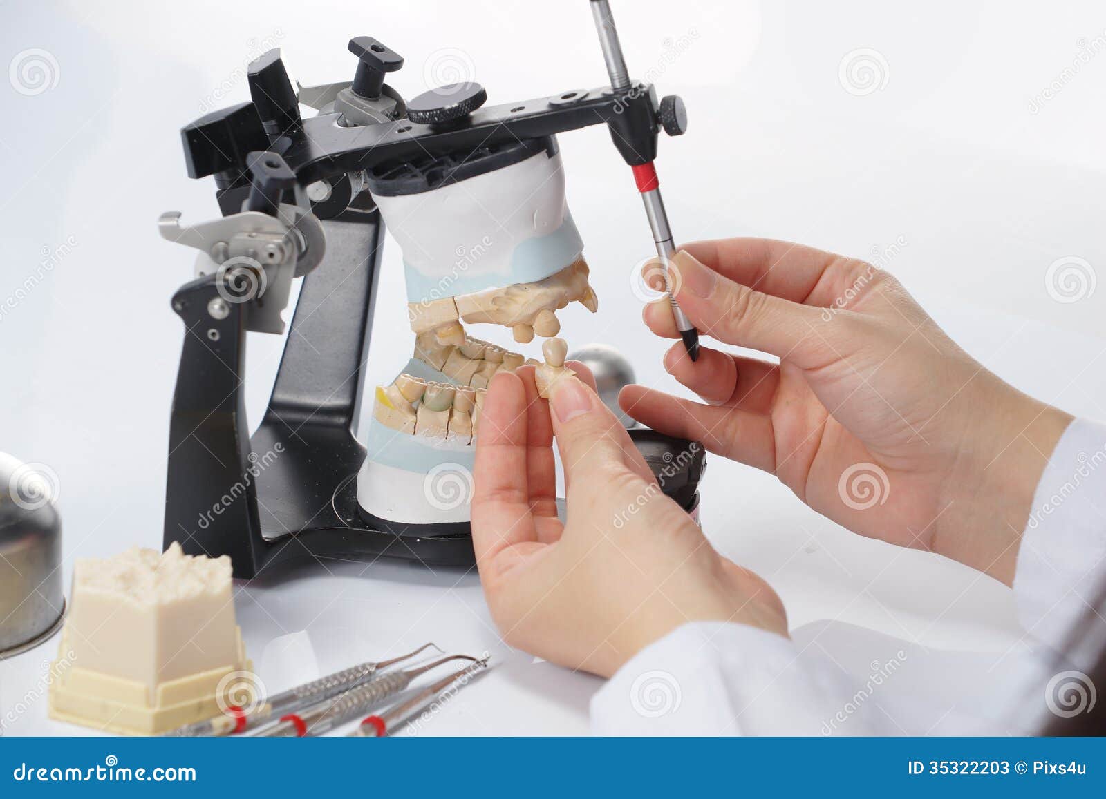 Dental Technician Working with Articulator in Dental Laboratory Stock