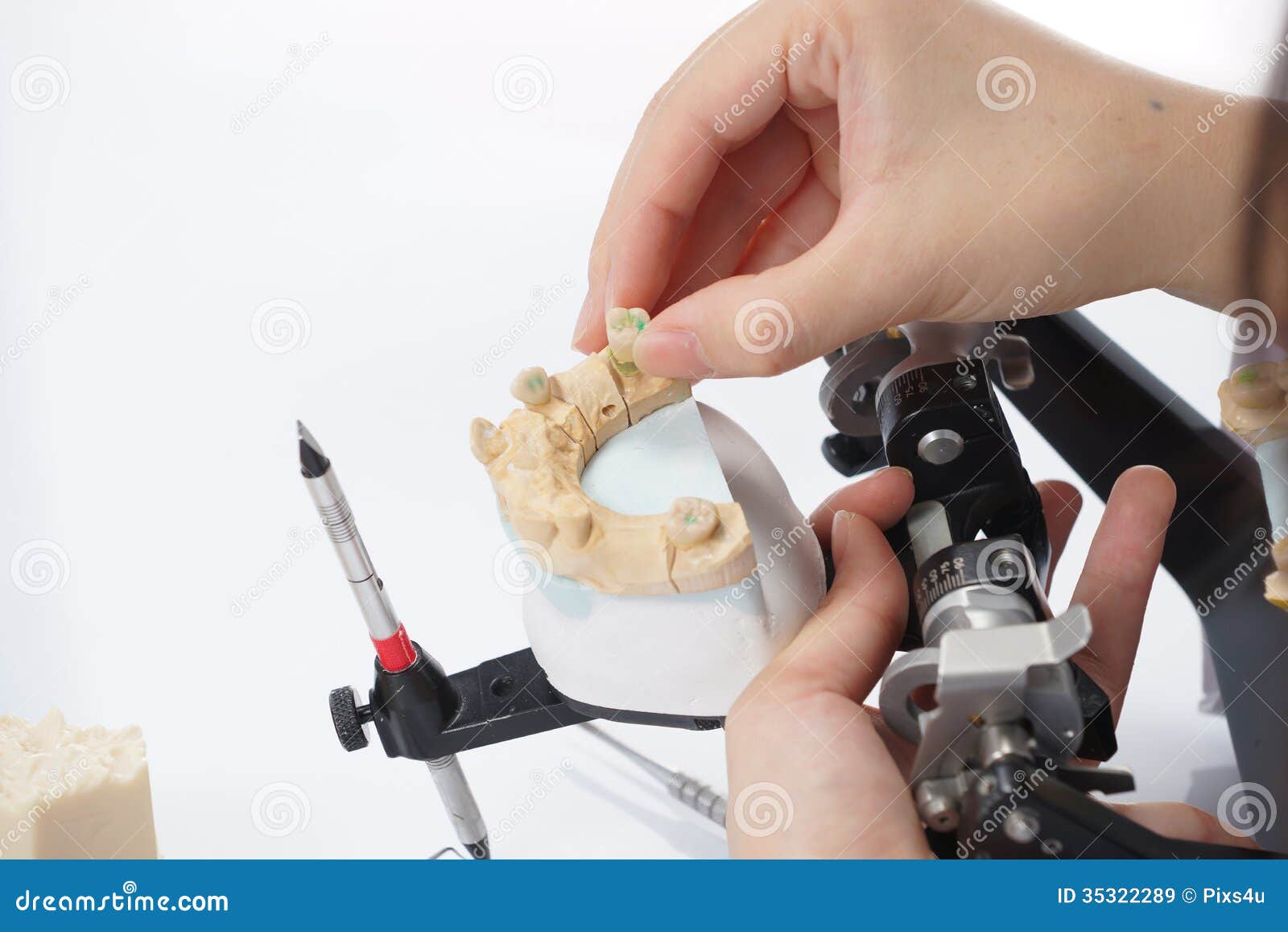 Dental Technician Working with Articulator in Dental Laboratory Stock