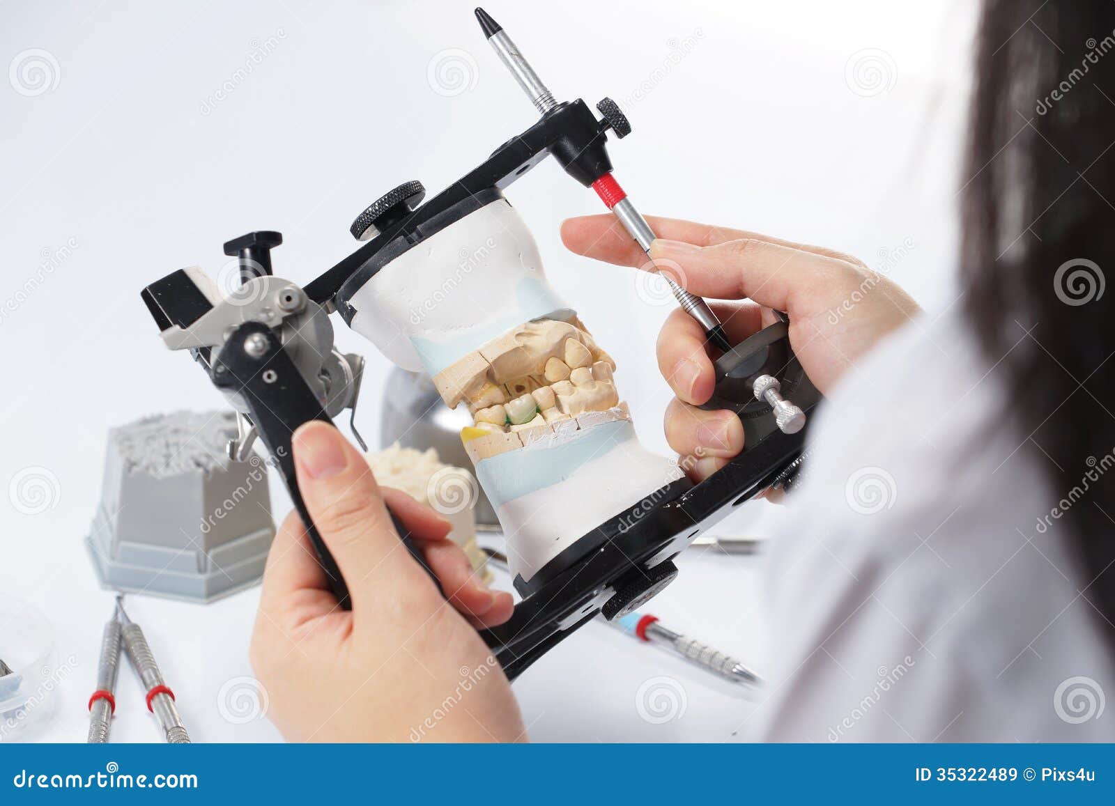 Dental Technician Working with Articulator in Dental Laboratory Stock