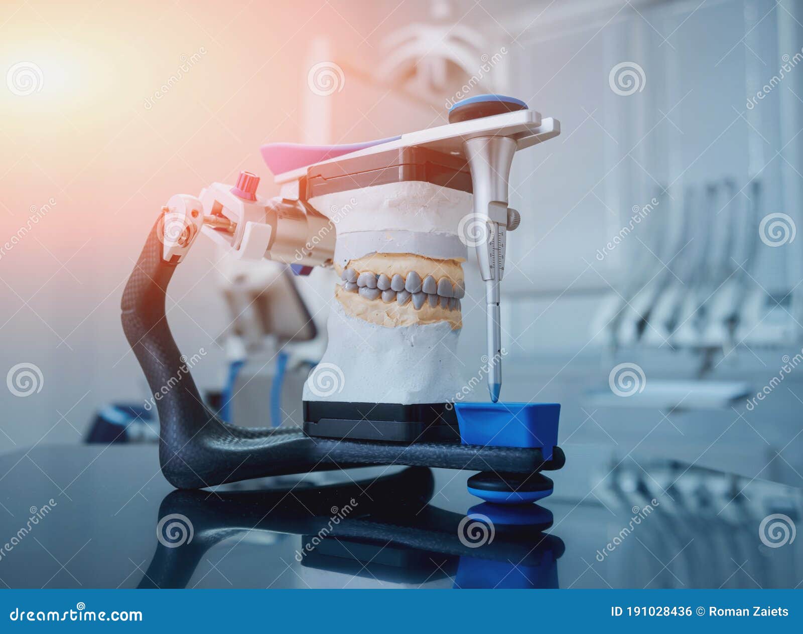 Dental Technician Working with Articulator in Dental Lab Stock Photo