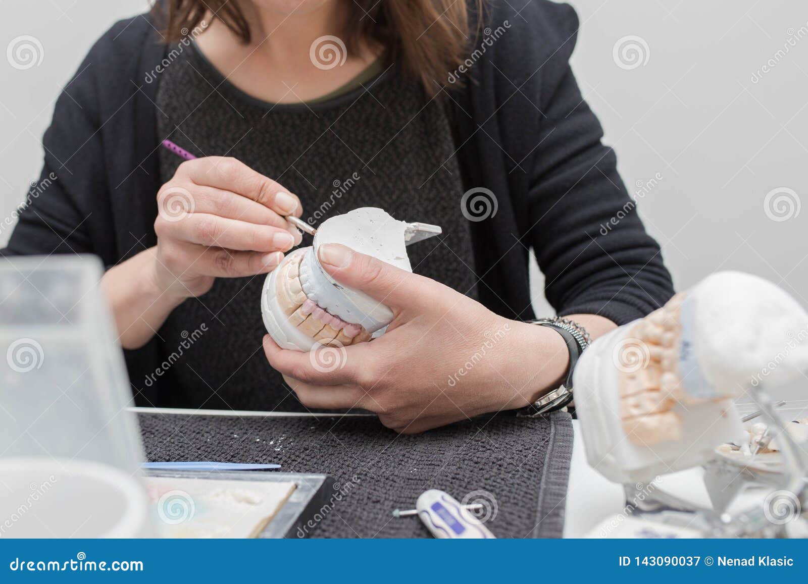 Dental Technician Working on Plaster Stone Model with Zirconium Bridge