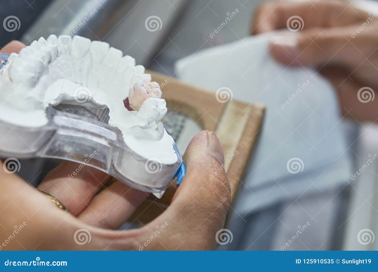 Dental Technician Working with Tools To Do Ceramic Dental Implants in