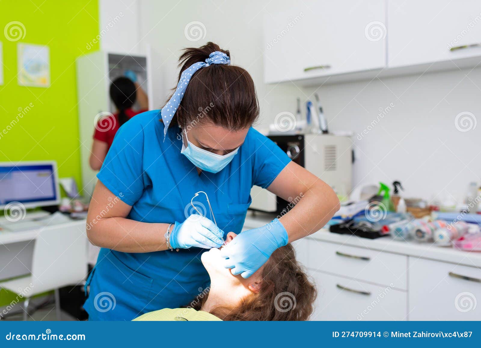 dentist appointment at a dental clinic, placing braces locks on the teeth and pulling the archwire to fix it