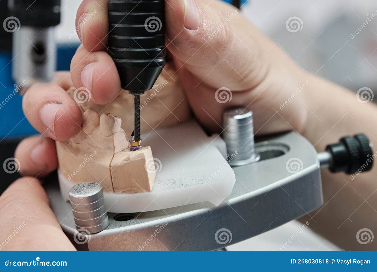 Dentist with Binocular Magnifying Glasses Working in Dental Clinic