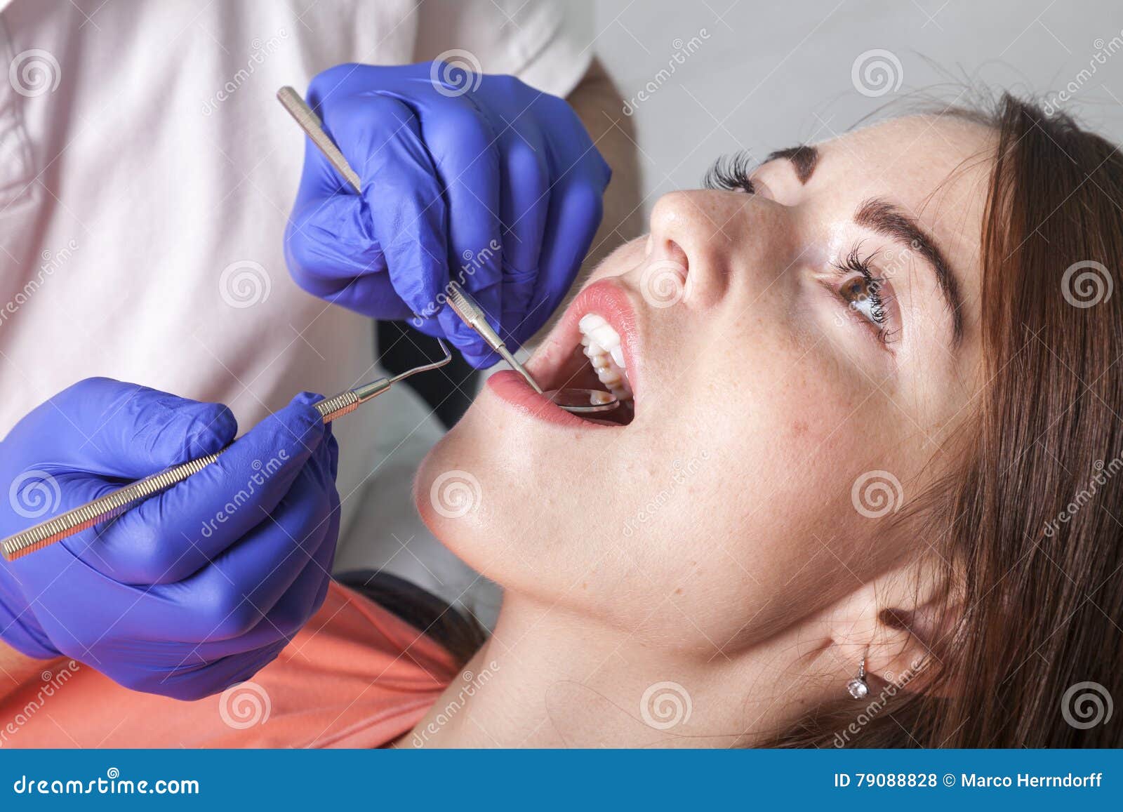 Dentist Checks Gums and Teeth with Mirror and Probe Stock Photo Image