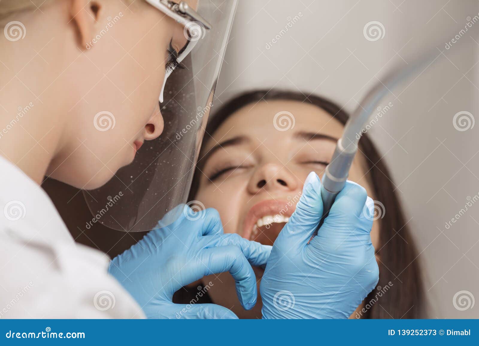 Dentist Doing A Dental Treatment On A Female Patient