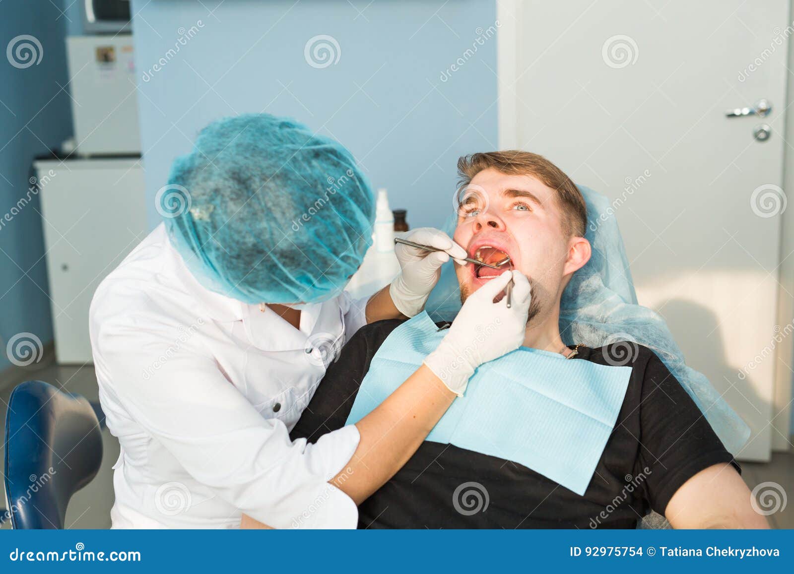 Dentist Doing a Dental Treatment on a Patient Stock Photo Image of