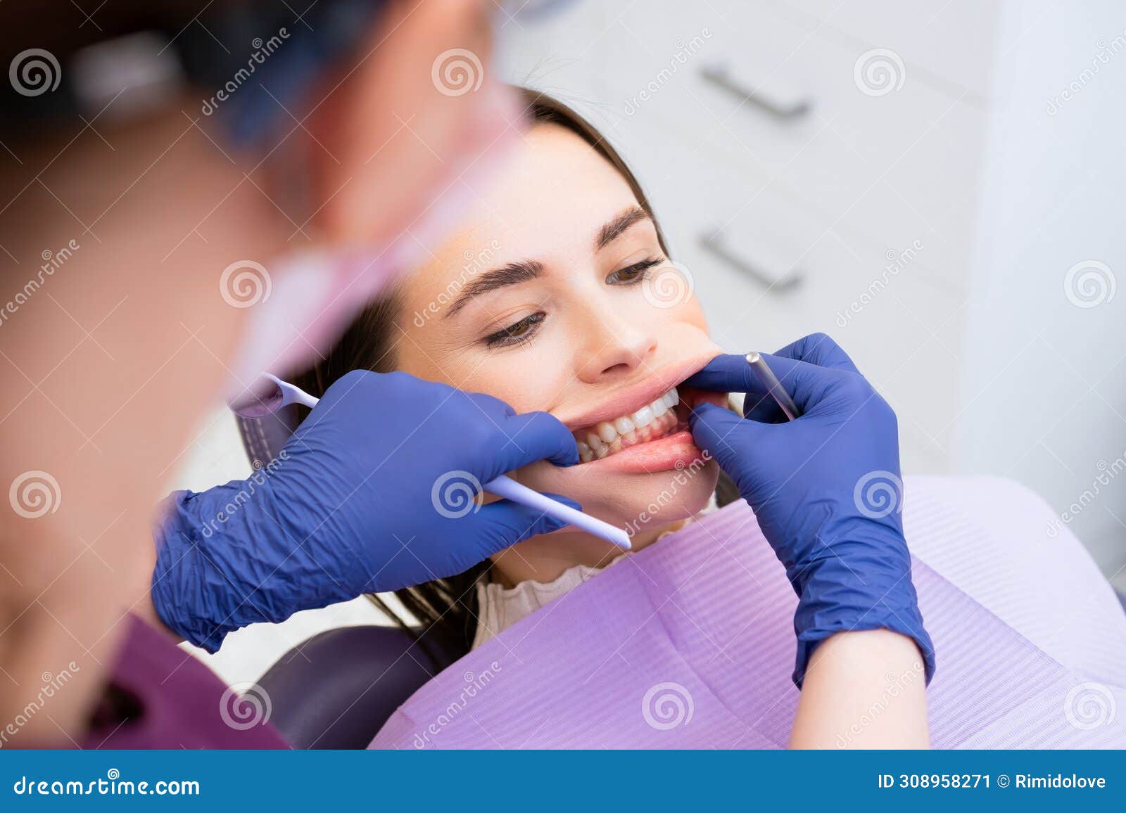 the dentist examines the patients bite at the dental office