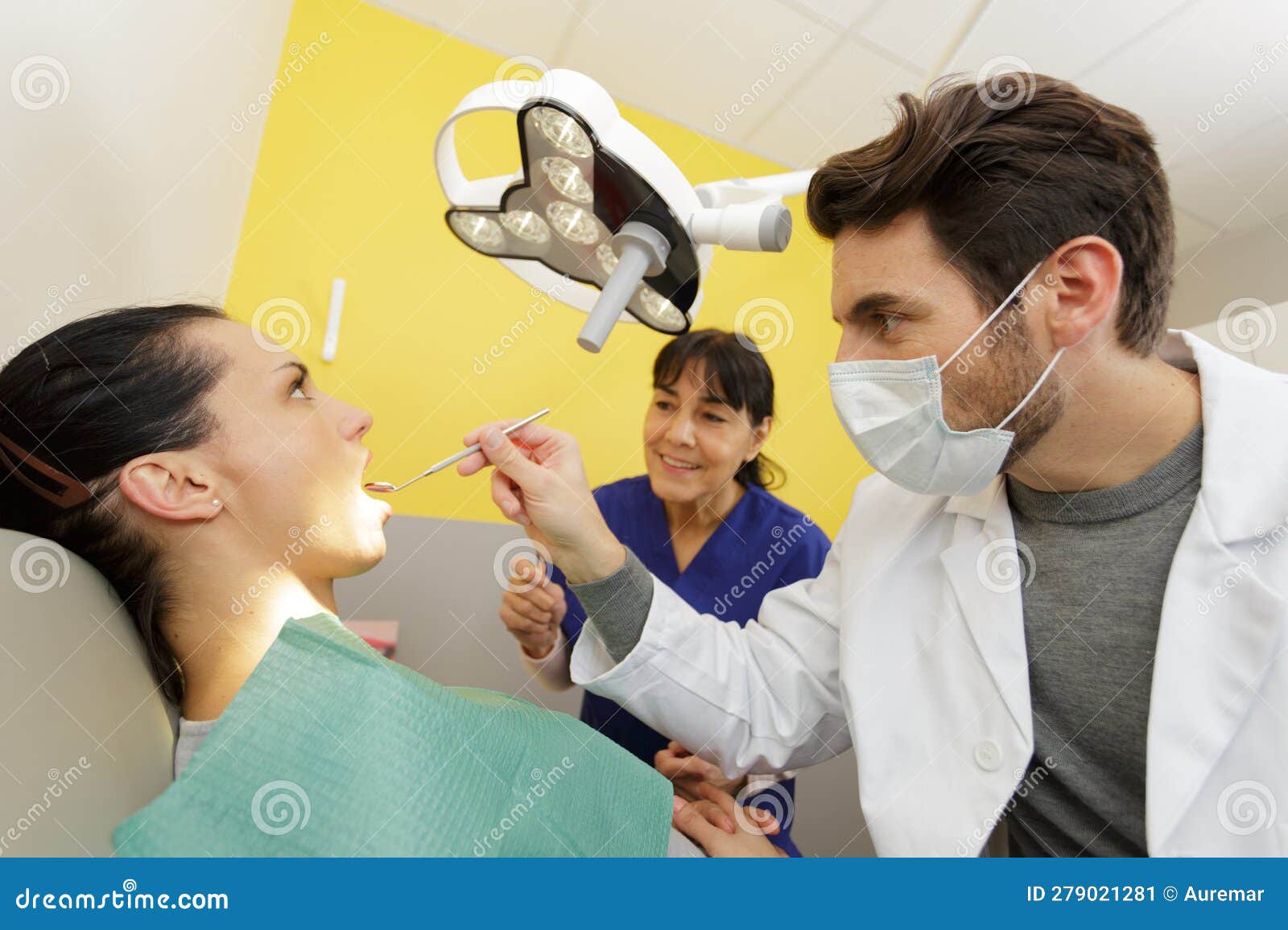 Dentist Examining Beautiful Patient in Dentists Office Stock Image