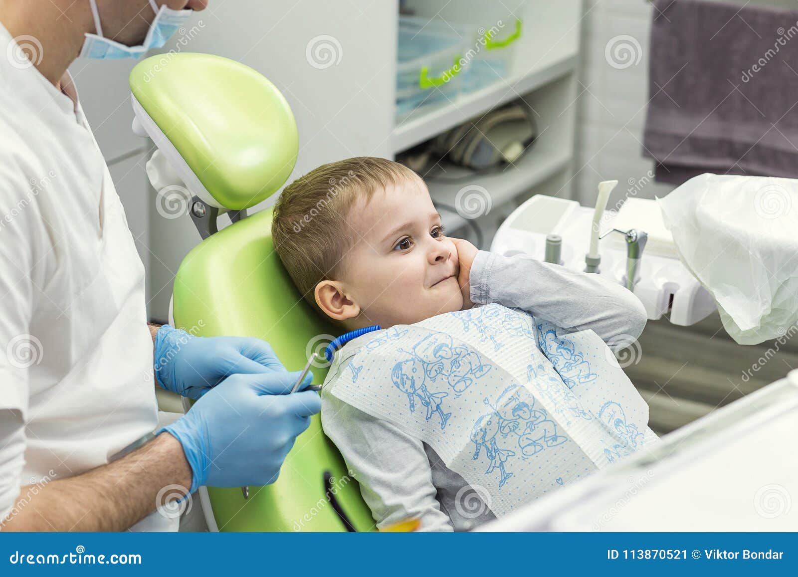 Dentist Examining Little Boy`s Teeth in Clinic. Dental Problem. Stock