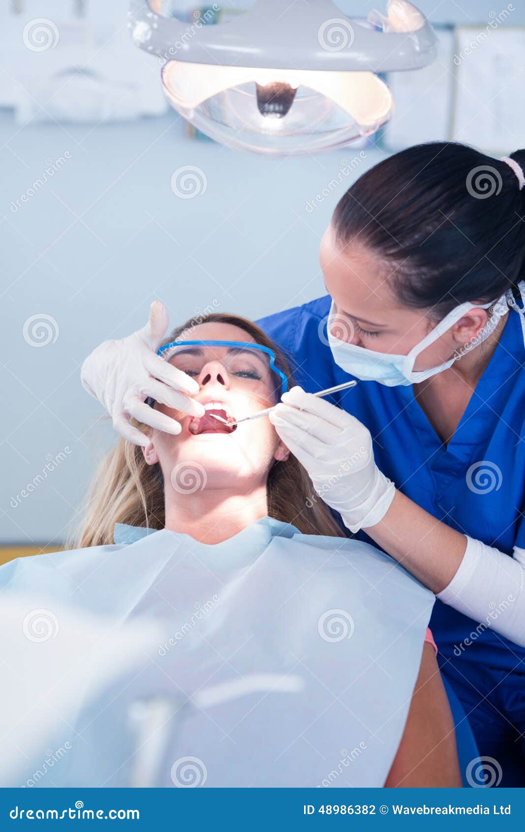 Dentist Examining a Patients Teeth Under Bright Light Stock Photo Image of occupation, front