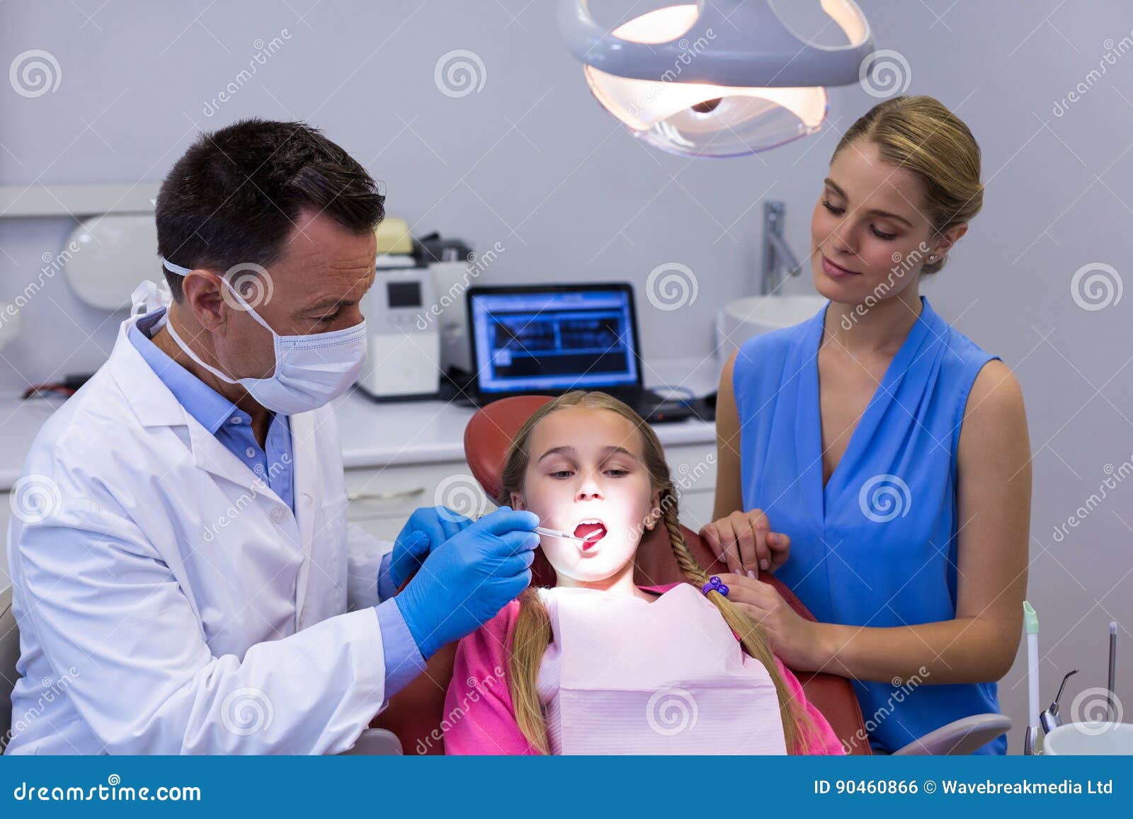 Dentist Examining a Young Patient with Tools Stock Photo Image of