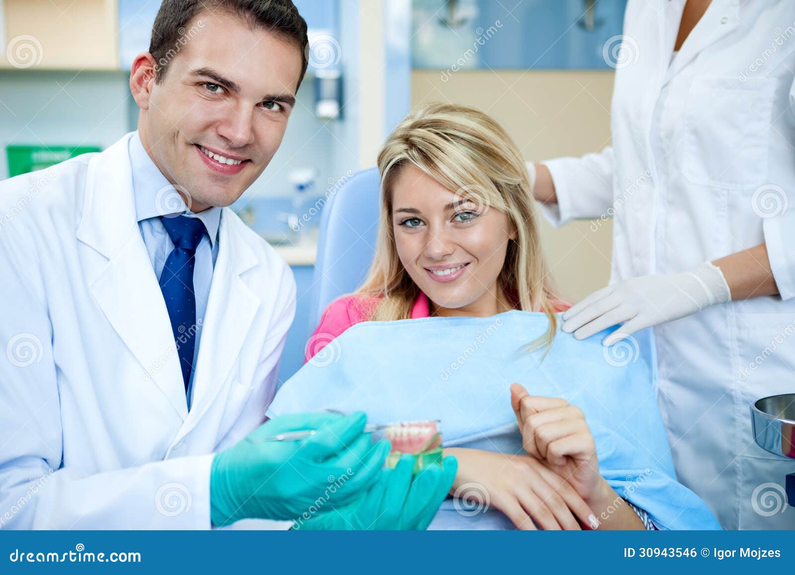 dentist explaining a female patient denture work