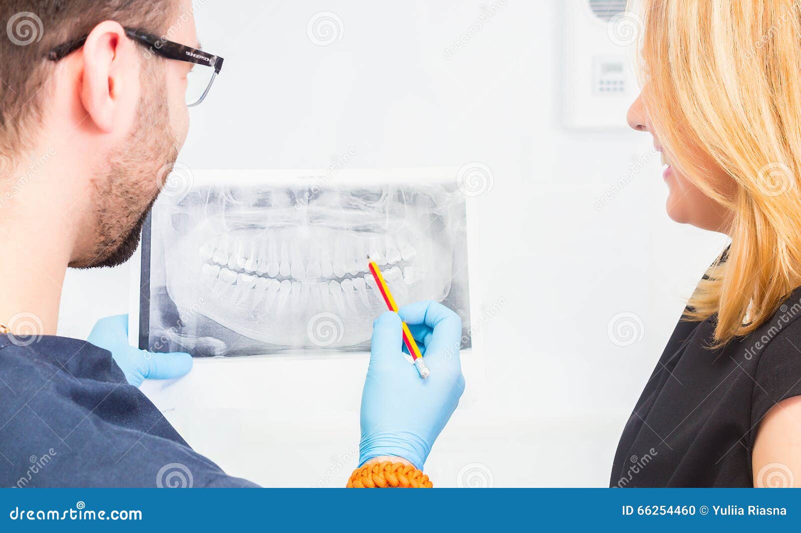 Dentist Explaining X Ray Picture To Patient. Stock Photo Image of