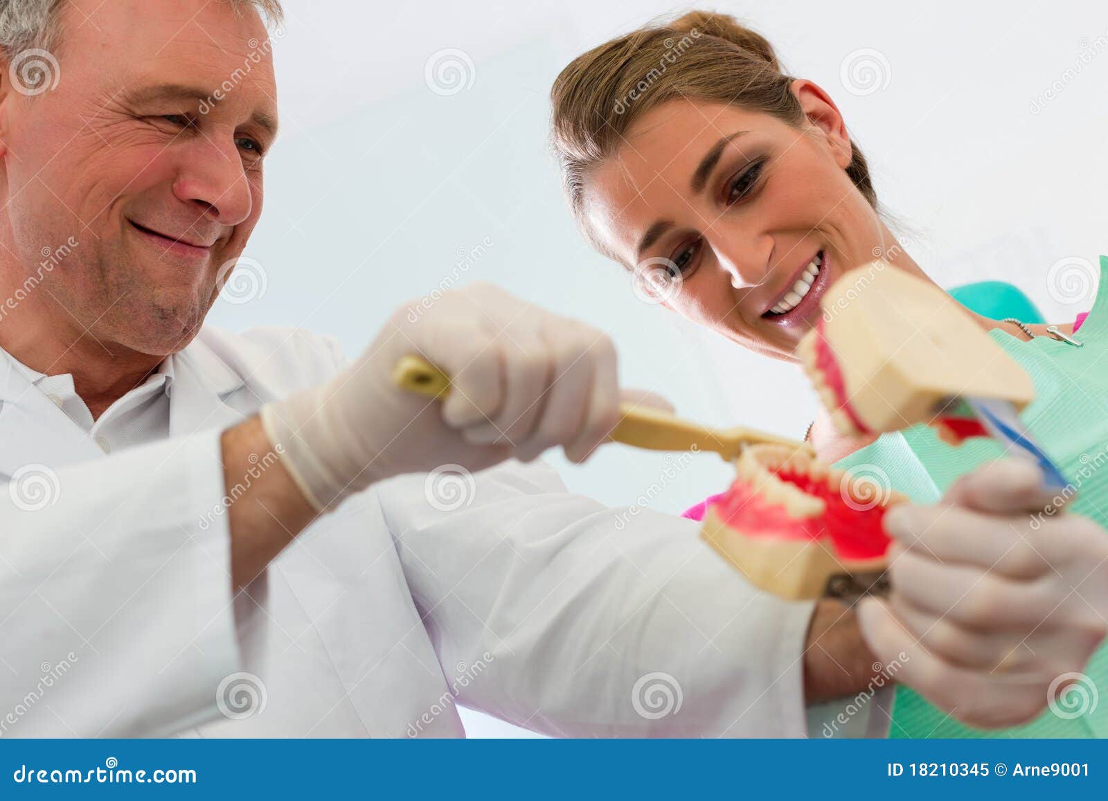 dentist explaining teeth brushing to patient