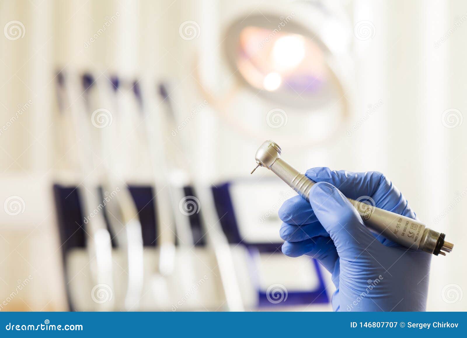 Dentist Hand with Drill Illustrates the Operation of the Dentist Dental