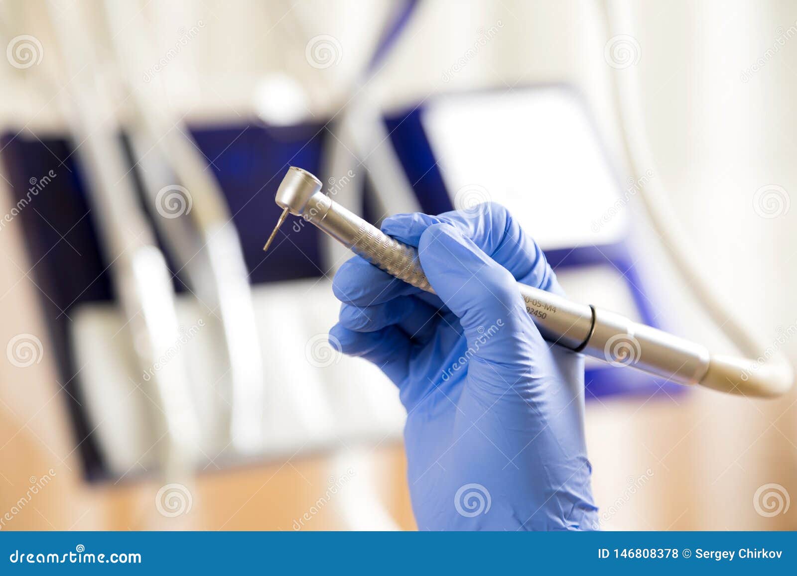 Dentist Hand with Drill Illustrates the Operation of the Dentist Dental