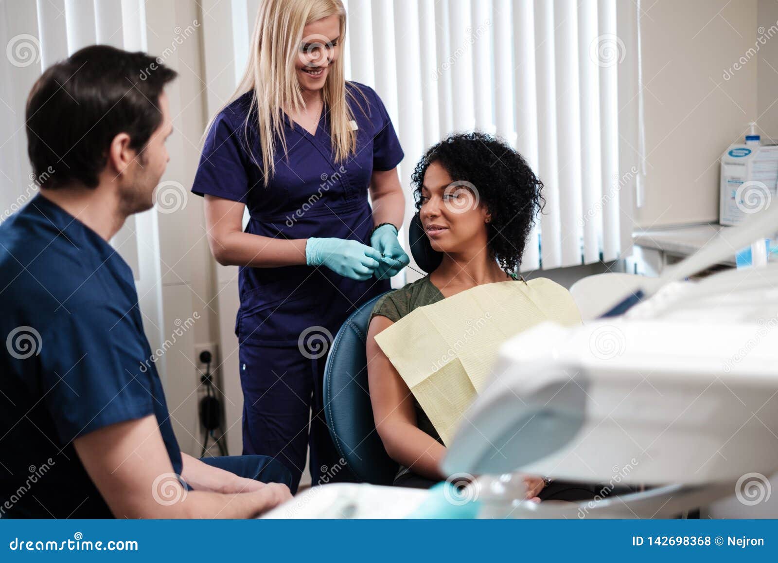 Dentist and His Assitant Working in Private Practice Stock Photo