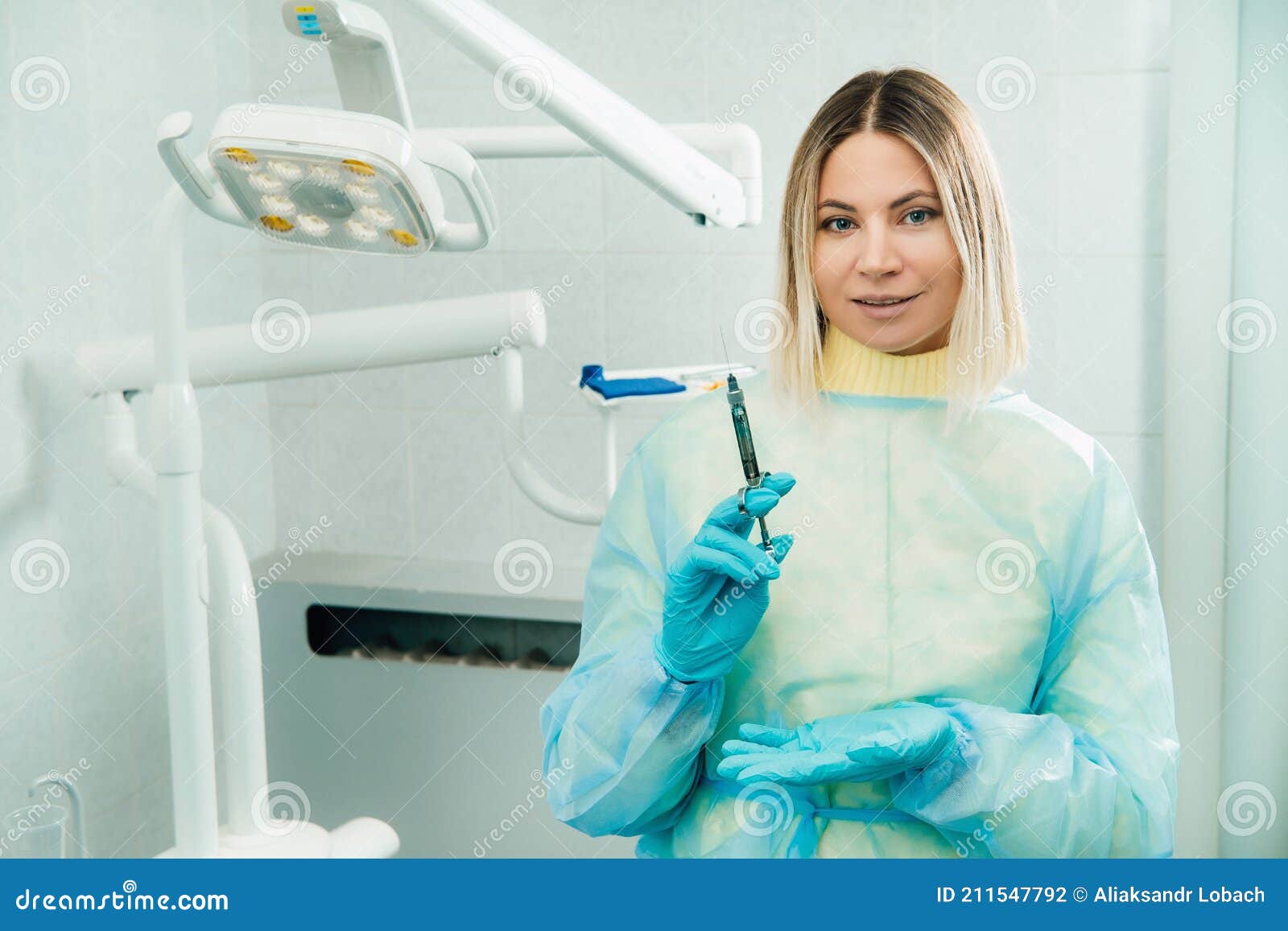 The Dentist Holds an Injection Syringe for the Patient in the Office