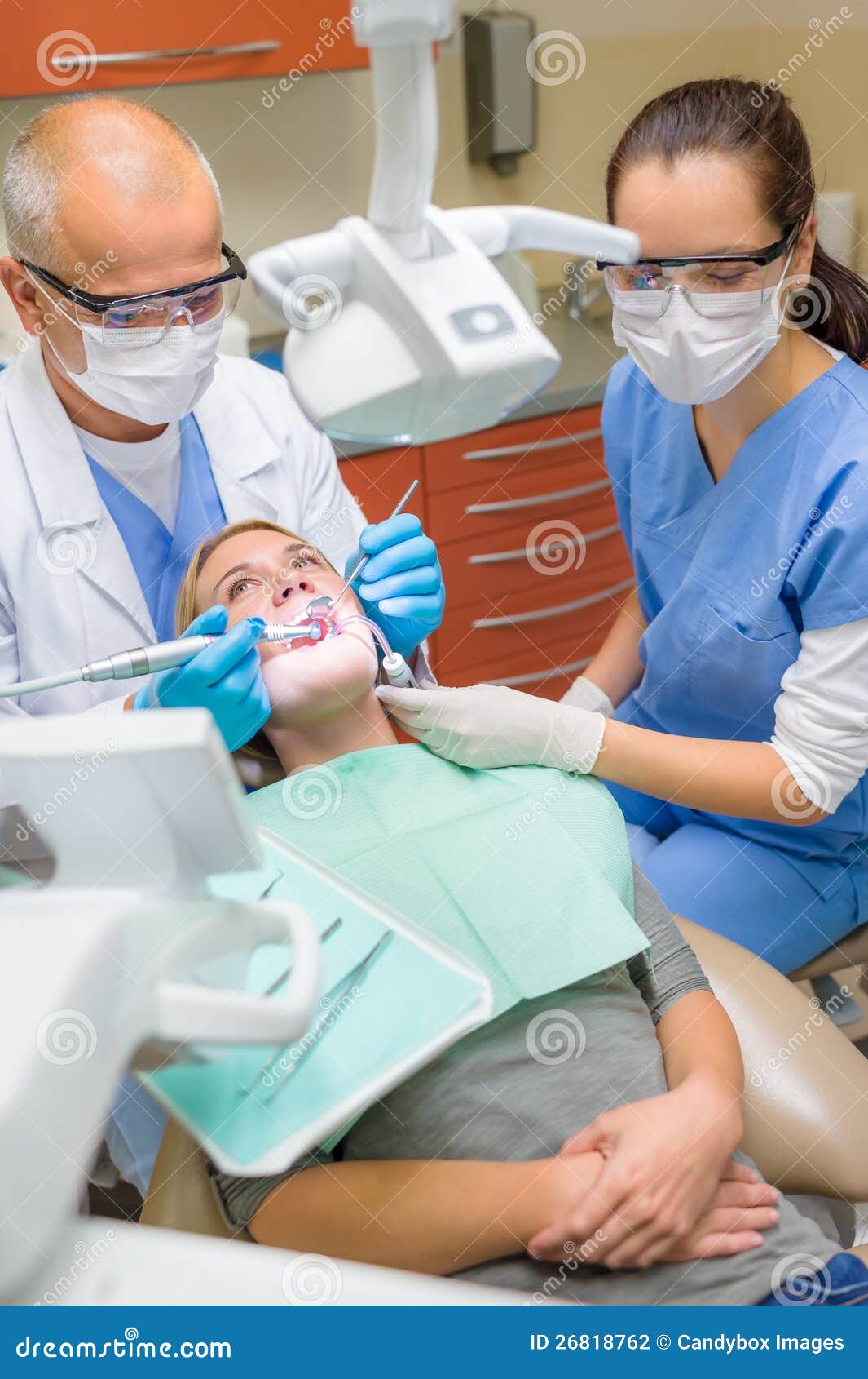 Dentist with Nurse Doing Procedure on Patient Stock Photo Image of