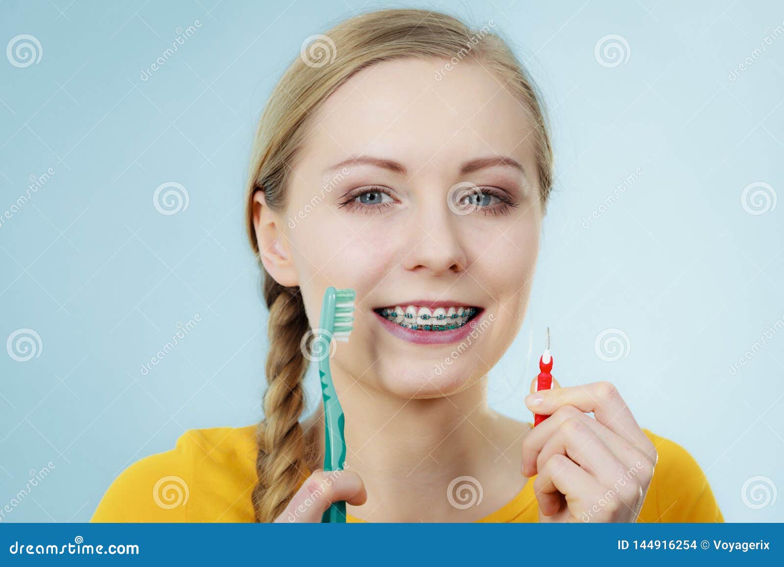 Girl With Teeth Braces Using Interdental And Traditional Brush Sto