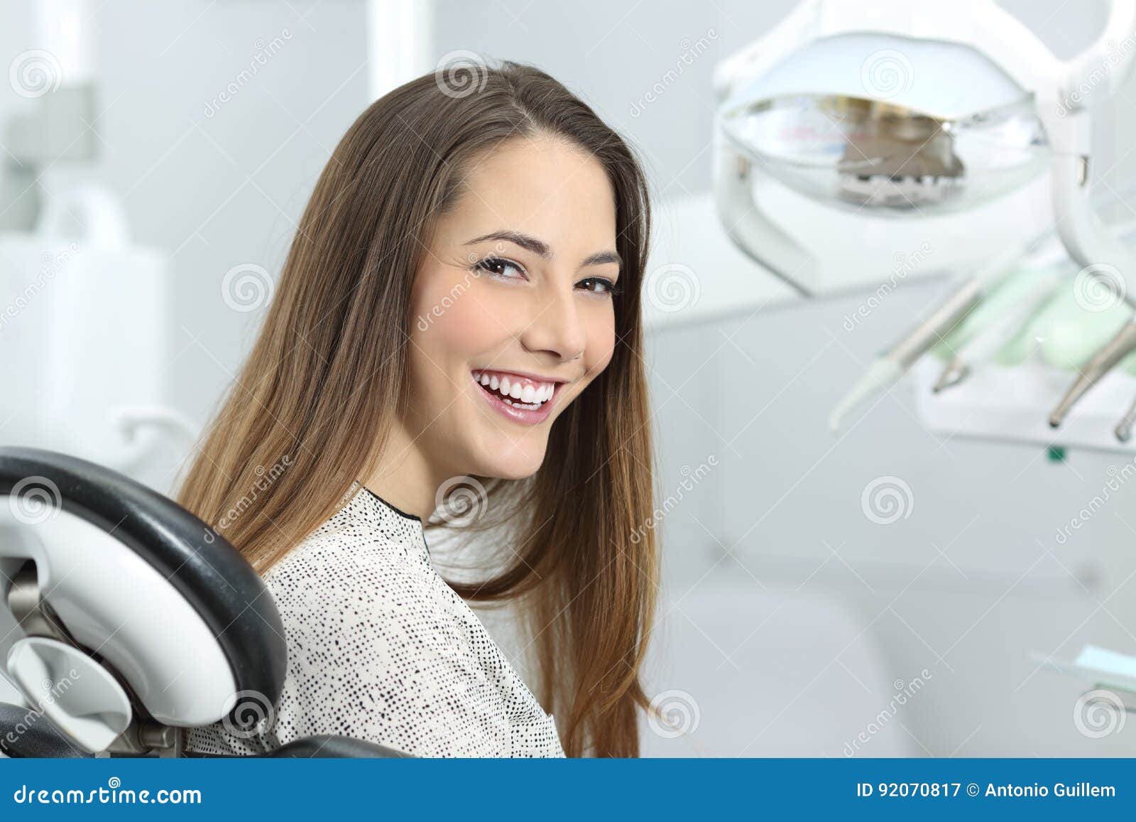 dentist patient showing perfect smile after treatment