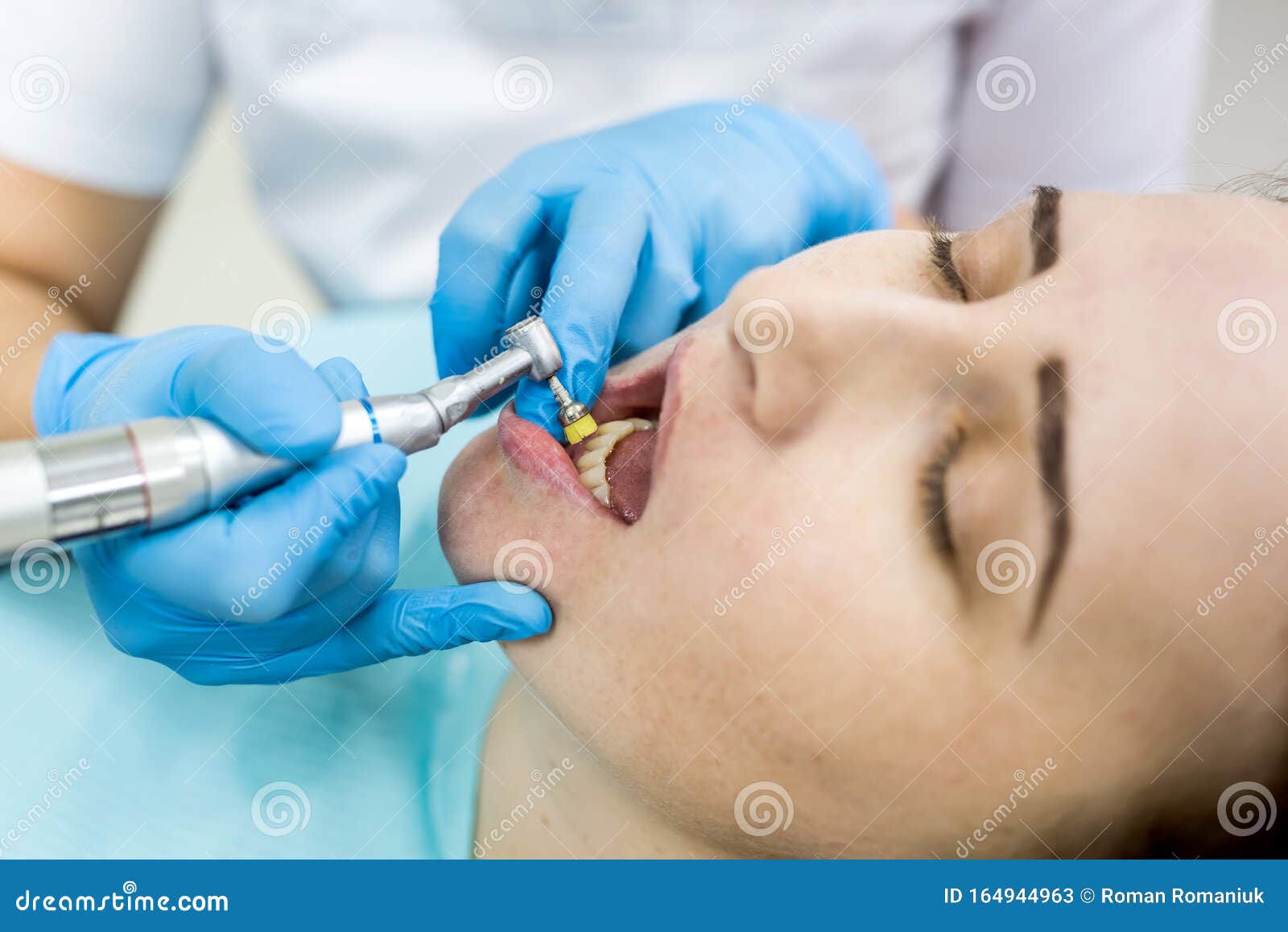 Dentist Polishing Patient`s Teeth After Whitening