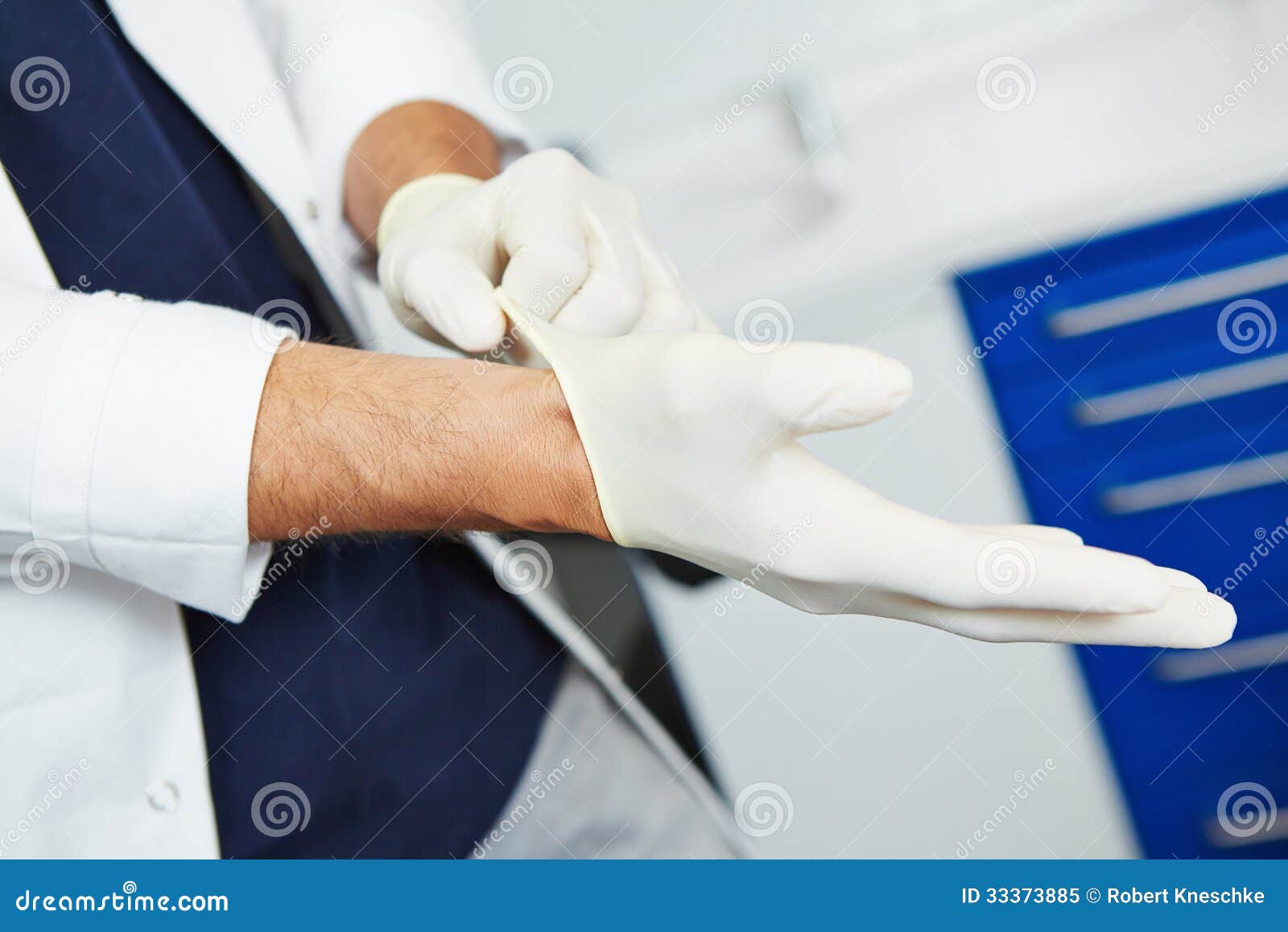 Dentist putting on gloves stock image. Image of healthcare 33373885