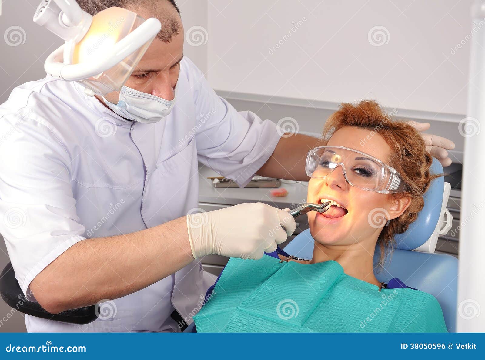 Dentist removes tooth stock photo. Image of caucasian 38050596