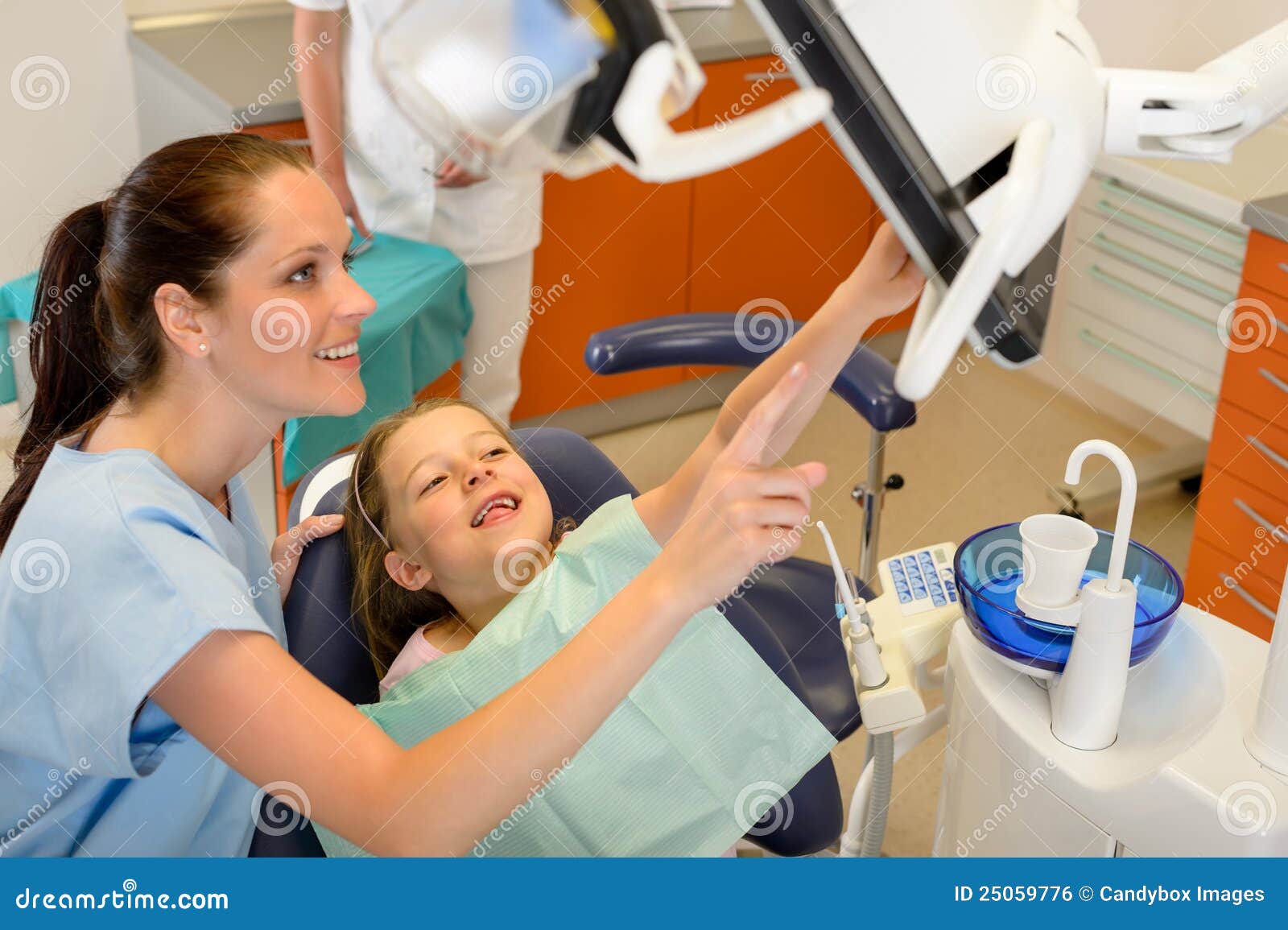 dentist showing child dental procedure on monitor