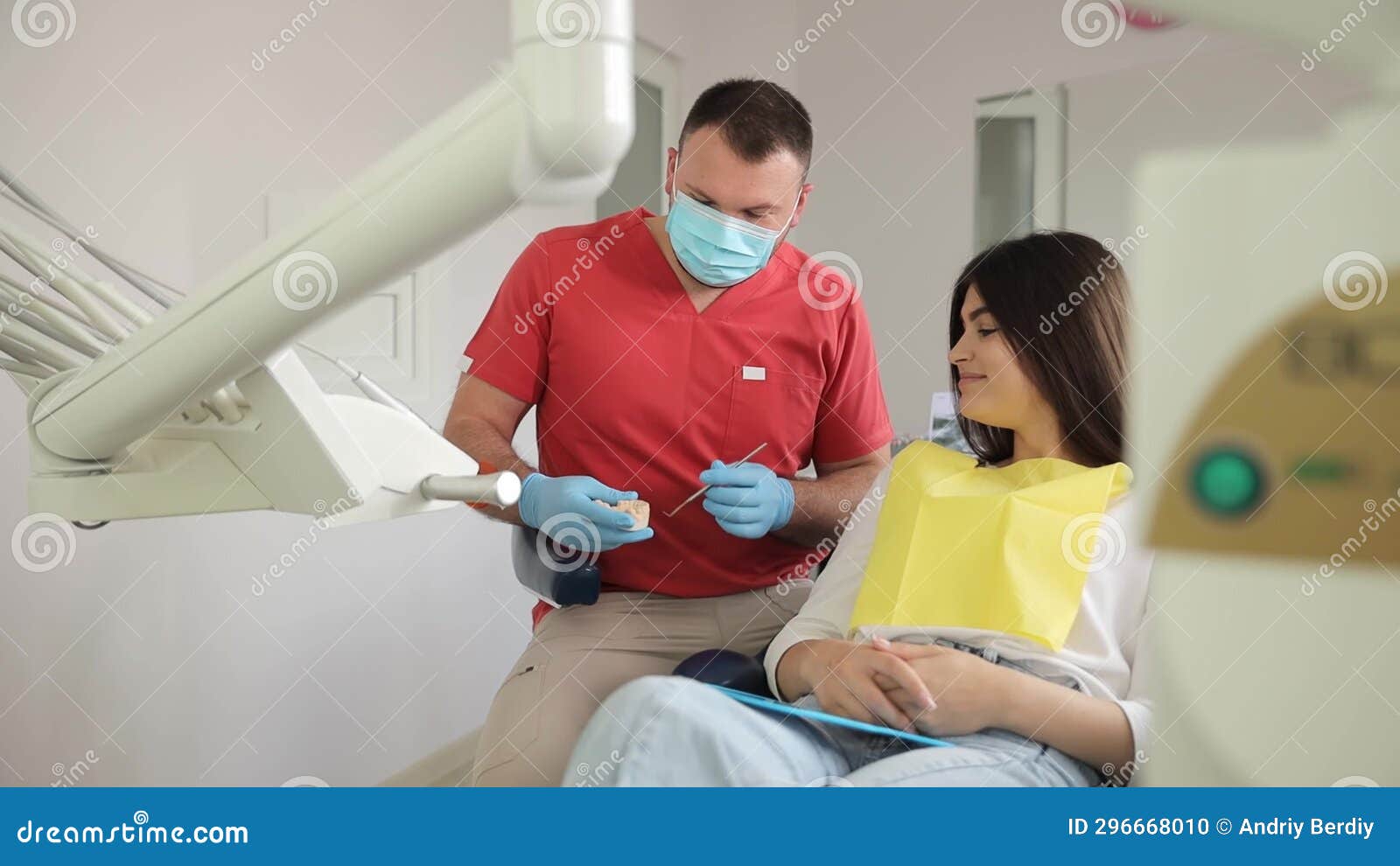 a dentist shows an orthodontic plastic jaw bite to a patient. health treatment of enamel.