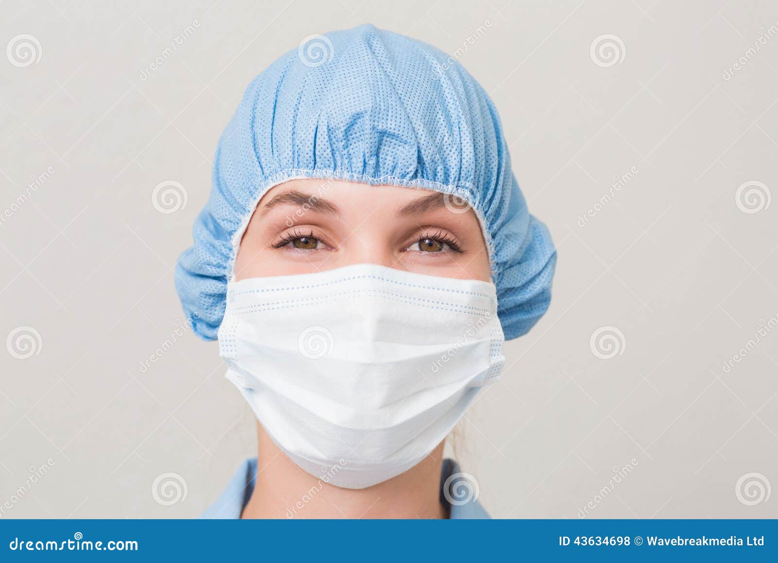 Dentist in Surgical Mask and Cap Looking at Camera Stock Photo Image
